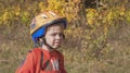 A boy in a helmet with a backpack rides a bicycle. Walk in the park Royalty Free Stock Photo