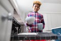 Boy Helping With Chores At Home By Stacking Crockery In Dishwasher Royalty Free Stock Photo