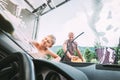 Boy helps his father with car washing