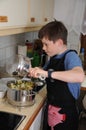 Boy preparing vegetarian meal with broccoli vegetable