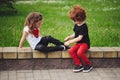 Boy helps little girl tie shoelaces Royalty Free Stock Photo