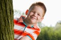 Boy hiding behind tree Royalty Free Stock Photo