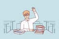 Boy high school student sits at desk with textbooks and workbooks and pulls hand up. Vector image