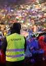 Boy with high visibility jacket with text STAFF during the live