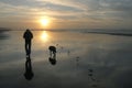 Boy with his dog at sunset on the beach. Royalty Free Stock Photo