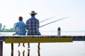 Boy and his father fishing togethe
