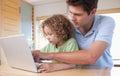 Boy and his father using a laptop Royalty Free Stock Photo