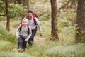 A boy and his father walking together on a trail between trees in a forest, both smiling, elevated view Royalty Free Stock Photo