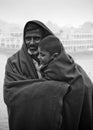 Bangladesh Ã¢â¬â January 06, 2014: A boy and his father watching the winter river with the full body of wearing a thick blanket on a