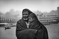 Bangladesh Ã¢â¬â January 06, 2014: A boy and his father watching the winter river with the full body of wearing a thick blanket on a