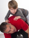 A boy on his fathers back, parenting can be diffic Royalty Free Stock Photo