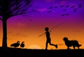 A boy with his fishing pole and his dog are seen returning home at sunset. Royalty Free Stock Photo