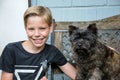 Boy and his friend a brown cairn terrier