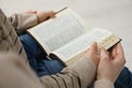 Boy and his godparent reading Bible together, closeup