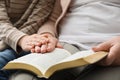 Boy and his godparent reading Bible together, closeup