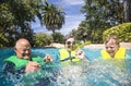 A boy and his grandparents splashing, playing, and having fun at a water park Royalty Free Stock Photo