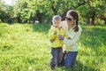 Boy and his mom making with before blowing dandelion Royalty Free Stock Photo