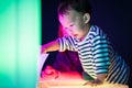 A boy and his mom are playing colorful light cubes.