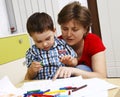 Boy with his mother learns to draw