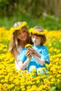 Boy and his Mother Sitting in a Dandelion Field Royalty Free Stock Photo