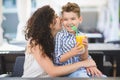 Boy and his mother tasting dessert with juice in resort restaurant outdoor