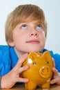 Boy and his piggybank Royalty Free Stock Photo