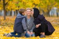 Boy and his sister kissing their mother in park. Royalty Free Stock Photo