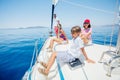 Boy with his sister and mother on board of sailing yacht on summer cruise.