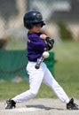 Boy hitting baseball