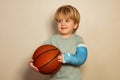 Boy hold basketball ball with broken hand in plaster cast Royalty Free Stock Photo