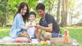 Boy hold money saving house box with mother and father in park.Happy family picnic concept Royalty Free Stock Photo