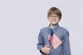 Boy holding american flag. Portrait of teenager with USA flag on white background. Celebrating July 4th