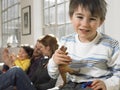 Boy Holding Animal Toy With Family Smiling In Background Royalty Free Stock Photo