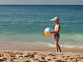 Boy holding ball on sea sand beach Royalty Free Stock Photo