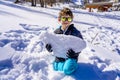 A boy holding a big piece of snow. Child playing with snow in frosty winter park Royalty Free Stock Photo