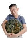 Boy holding big pumpking on white background..