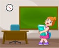 The girl is holding the big Tosca book near the teacher`s desk Royalty Free Stock Photo