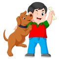 A boy holding bone with his dog Royalty Free Stock Photo