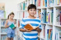 Boy holding a book in library Royalty Free Stock Photo