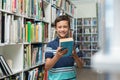 Boy holding book in library at school Royalty Free Stock Photo