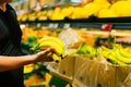 Boy holding a bunch of bananas in the supermarket Royalty Free Stock Photo