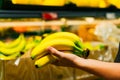 Boy holding a bunch of bananas in the supermarket Royalty Free Stock Photo