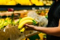 Boy holding a bunch of bananas in the supermarket Royalty Free Stock Photo