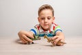 Boy holding dinosaur toys. Concept of developing attention in children through play Royalty Free Stock Photo