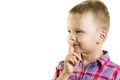 Boy holding a finger near lips Royalty Free Stock Photo