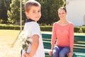 Boy holding flowers behind his back Royalty Free Stock Photo