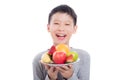 Boy holding fruits and smiles over white background Royalty Free Stock Photo