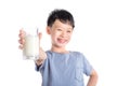 Boy holding a glass of milk over white background
