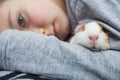 Boy holding a guinea pig. A child hugs a guinea pig. Pet care concept Royalty Free Stock Photo