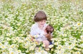 Boy holding his newborn baby sister in flowers Royalty Free Stock Photo